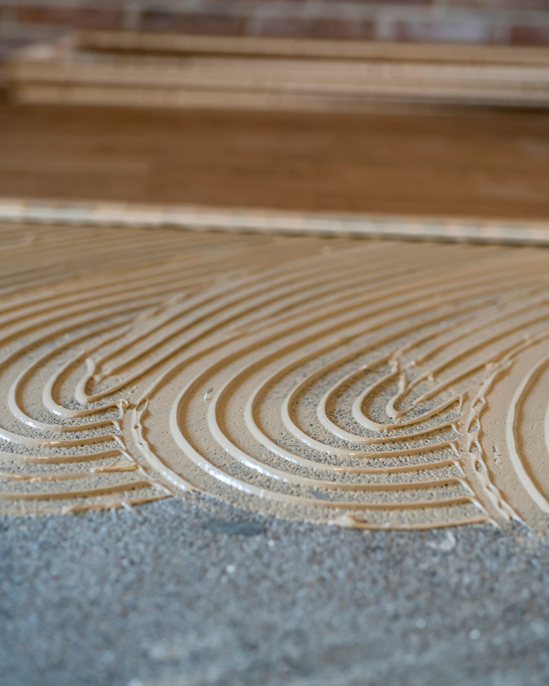 Glue-down flooring installation by Artist Flooring crew