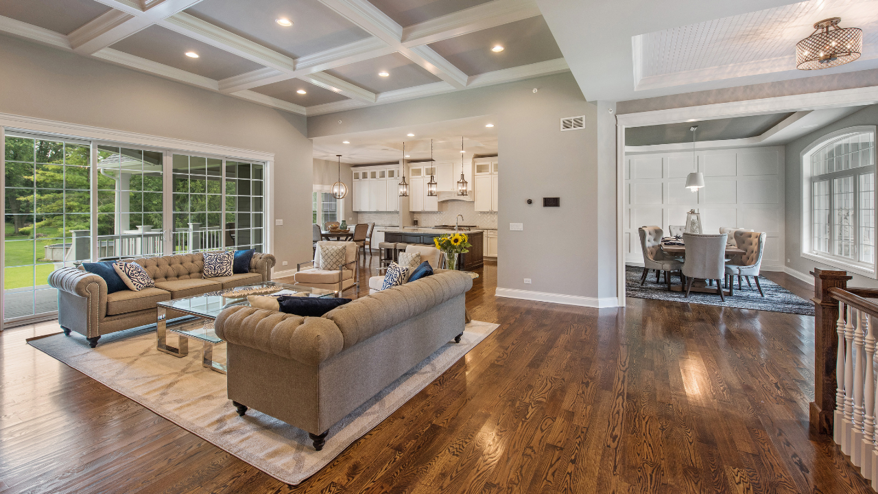 Hardwood flooring continuous through an open-concept Tampa Bay home, living, dining and kitchen, installed by Artist Flooring and Shower