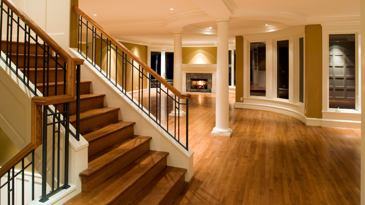 Hardwood floors flowing from staircase into open living area