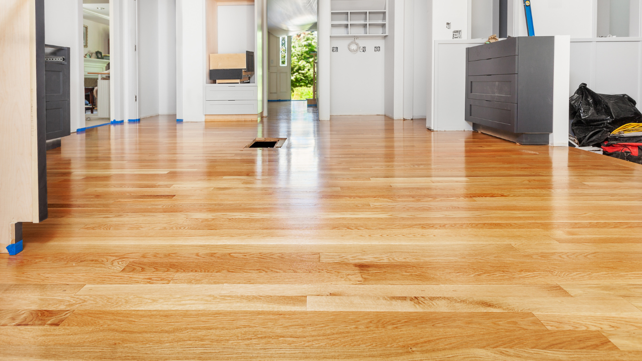 Hardwood plank being installed by Artist Flooring crew