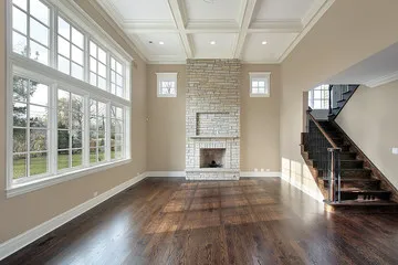 Wide-plank hardwood flooring in a bright Tampa Bay living room installed by Artist Flooring